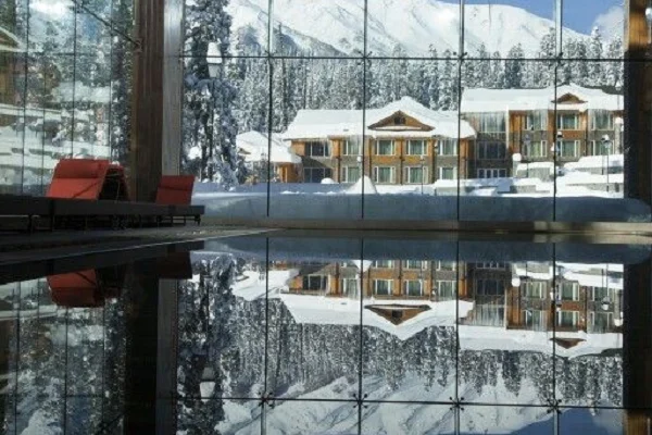 View of snow-covered hotel through glass wall
