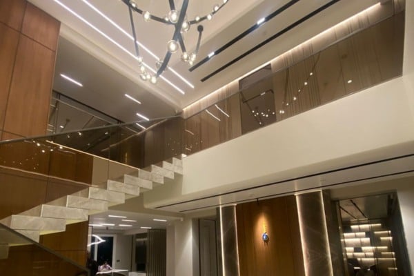 Double-Height Living Area with Tinted Glass Railings 