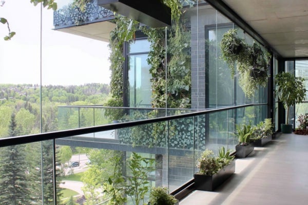 Glass Railings Paired With Planters Soften Balcony Edges
