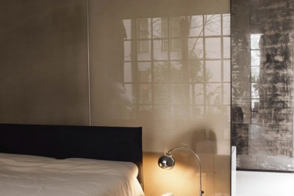 Glass headboard reflecting soft light